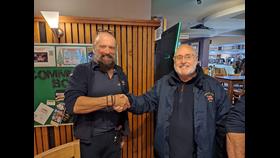 Two men in RNLI clothes shake hands