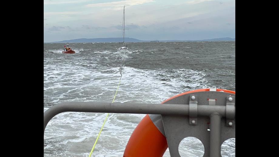Barry Dock RNLI lifeboat towing yacht towards Porthcawl in rough seas 