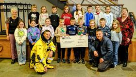 Primary 3/4 pupils from Whalsay School present a cheque for £1000 to Mechanic Paul Hutchison (front left) and John Angus (front right) of RNLI Lerwick, and Rhoda Watt (left) and Linda Simpson (right) of Lerwick Lifeboat Fundraising Crew.
