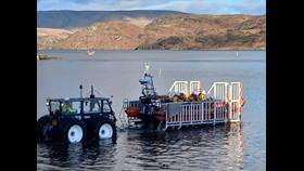 The tractor trailer manoeuvres into the water to launch the inshore lifeboat
