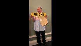 Robert McQueen with license plate presented by Portpatrick RNLI crew