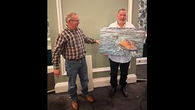 Jonathon Pearson presents the painting to Robert McQueen