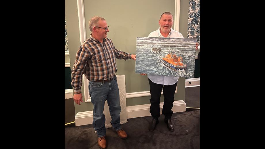 Jonathon Pearson presents the painting to Robert McQueen