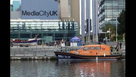 Pwllheli Shannon class all-weather lifeboat Smith Brothers 13-39 moored at Salford Quay in front of Media City UK building