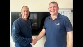 RNLI Assessor Dave Needham shakes hands with newly promoted Gravesend RNLI Commander Stewart Challis.