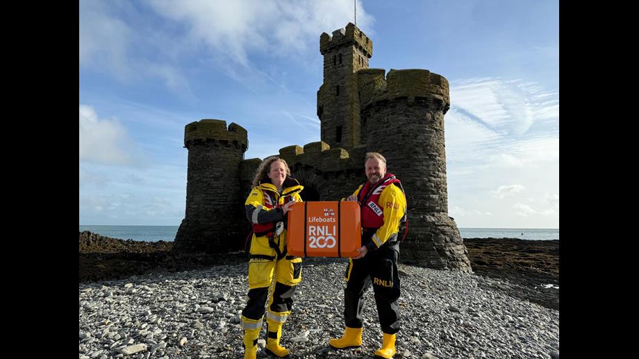 Douglas RNLI volunteer Coxswain, Emily Heaton and Port Erin Mechanic Jason Fleming with the scroll at the Tower of Refuge