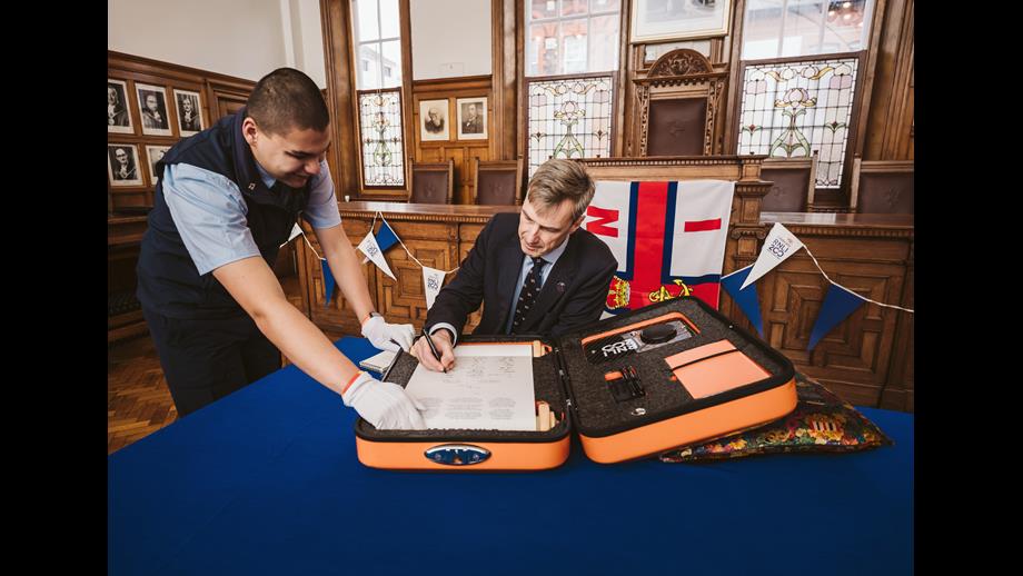RNLI Chief Executive Peter Sparkes adding his signature 
