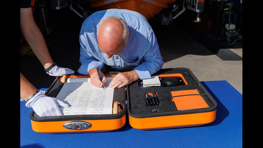 Sam Shiels signing the scroll
