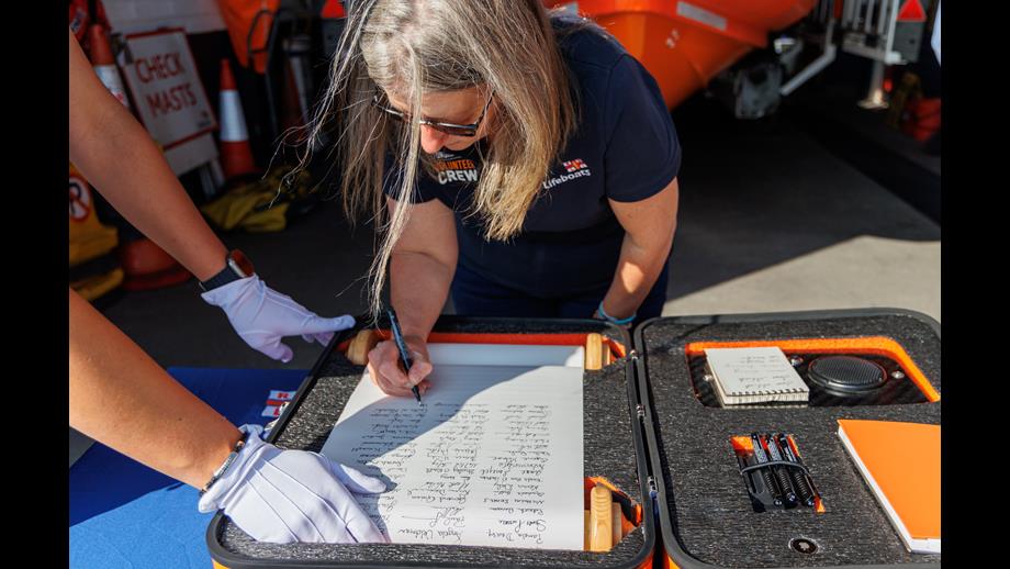 Cate Monaghan signing the scroll