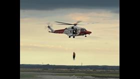 Crew member Jack is lifted from the scene by the Coastguard Rescue helicopter