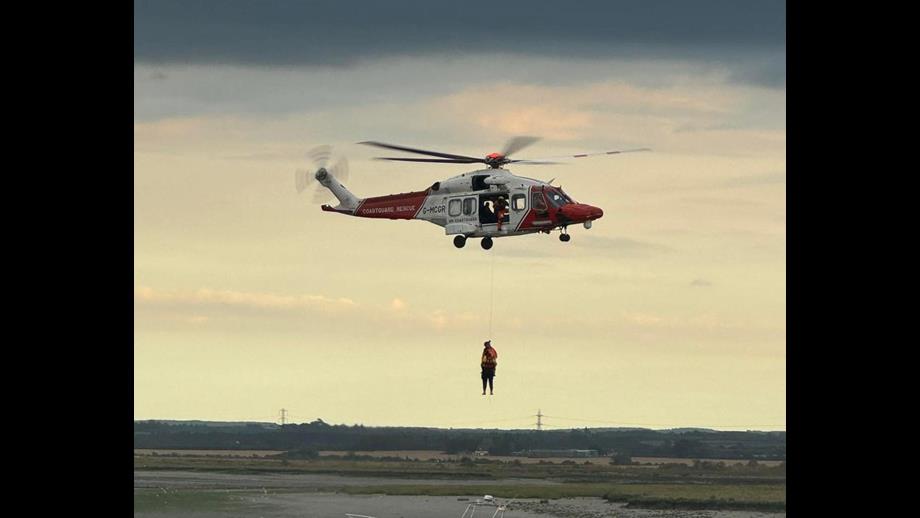 Crew member Jack is lifted from the scene by the Coastguard Rescue helicopter