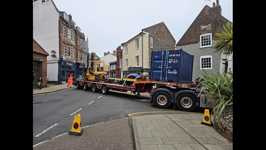 Specialist movers arrive at the RNLI Henry Blogg Museum in Cromer. A low loader is carefully guided through a narrow street in Cromer taking lifting gear and other specialist equipment ready for moving the historic lifeboat