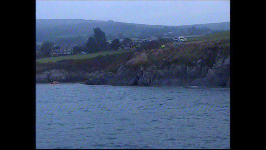 View from the all weather lifeboat of the scene with Coastguard on the clifftop and inshore lifeboat in the area of the old lifeboat station
