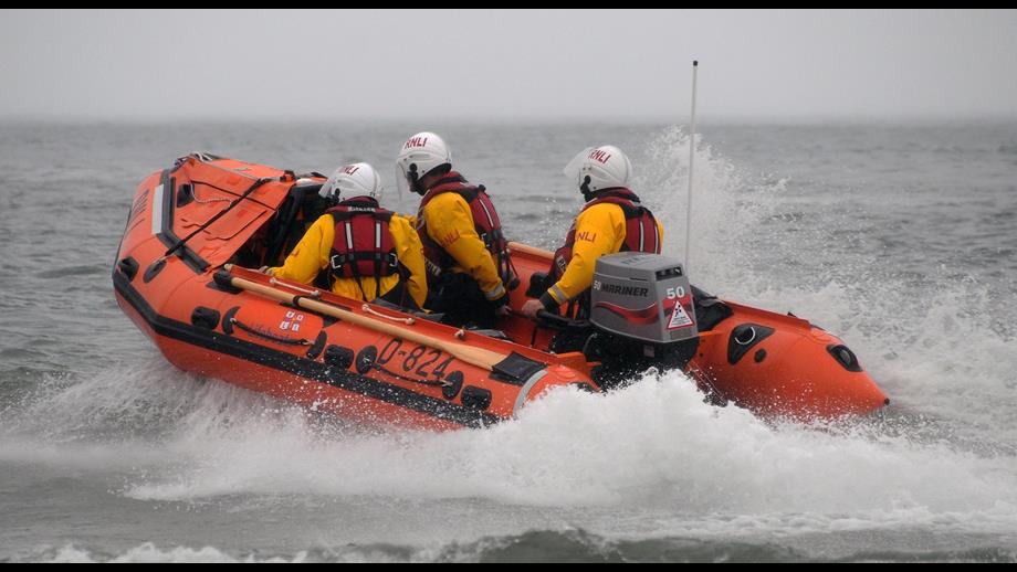 Inshore lifeboat moving though choppy seas.