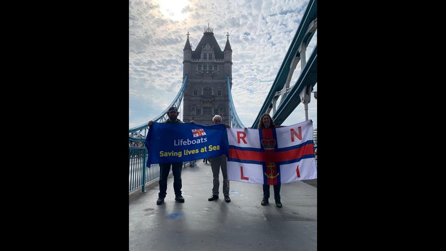 RNLI supporters on Tower Bridge holding RNLI flags 