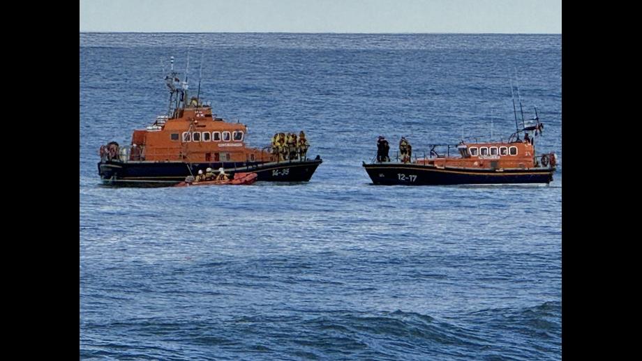 Three orange boats on water.