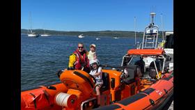 Heather with her young family on the RNLI Atlantic 85 inshore lifeboat
