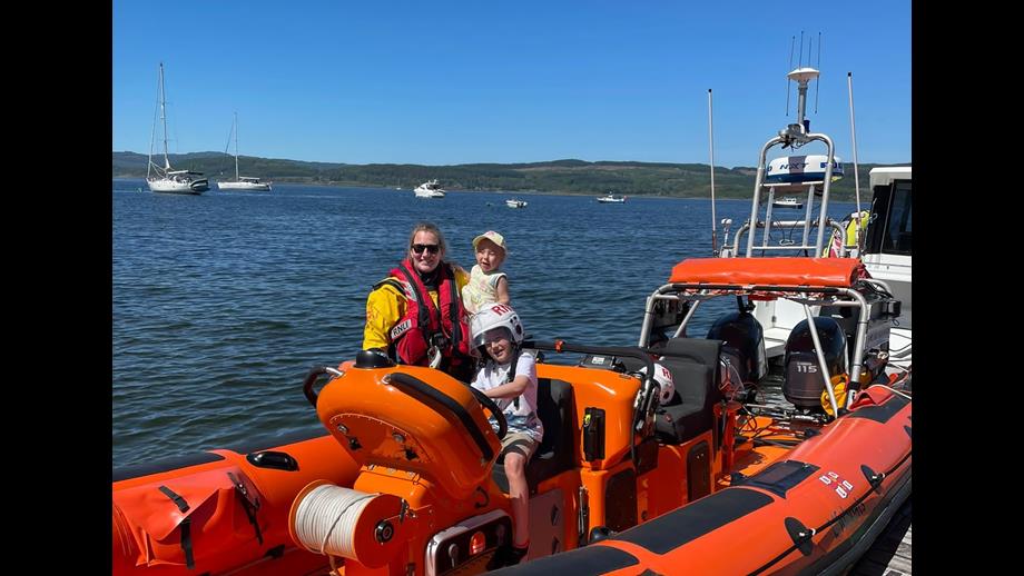 Heather with her young family on the RNLI Atlantic 85 inshore lifeboat