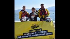 Gwen, Emily and Tim at Beaumaris Lifeboat Station with Mayday poster.