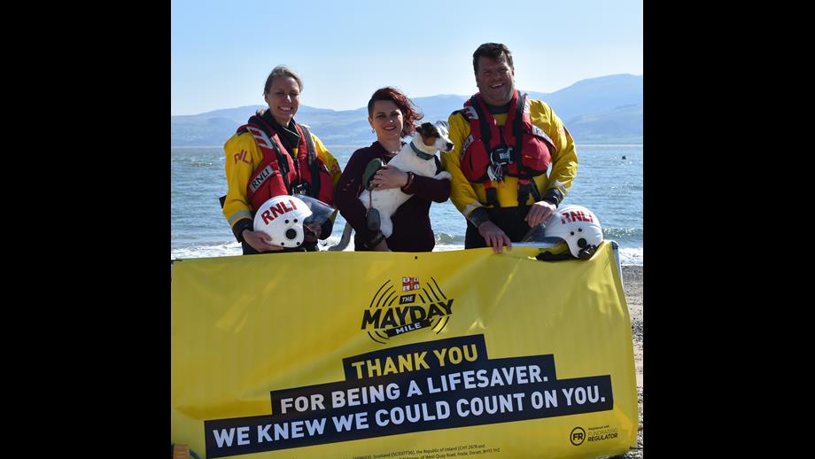 Gwen, Emily and Tim at Beaumaris Lifeboat Station with Mayday poster.