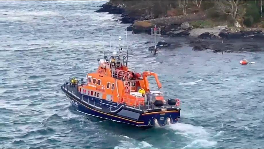 Islay all weather lifeboat side on in the water with some land in the background
