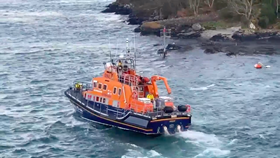 Islay all weather lifeboat side on in the water with some land in the background