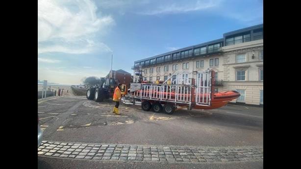 New Brighton boat and shore crew prepare the boat to be launched at the top of the slipway. Tractor can be seen, ready to go, ahead of the carriage.