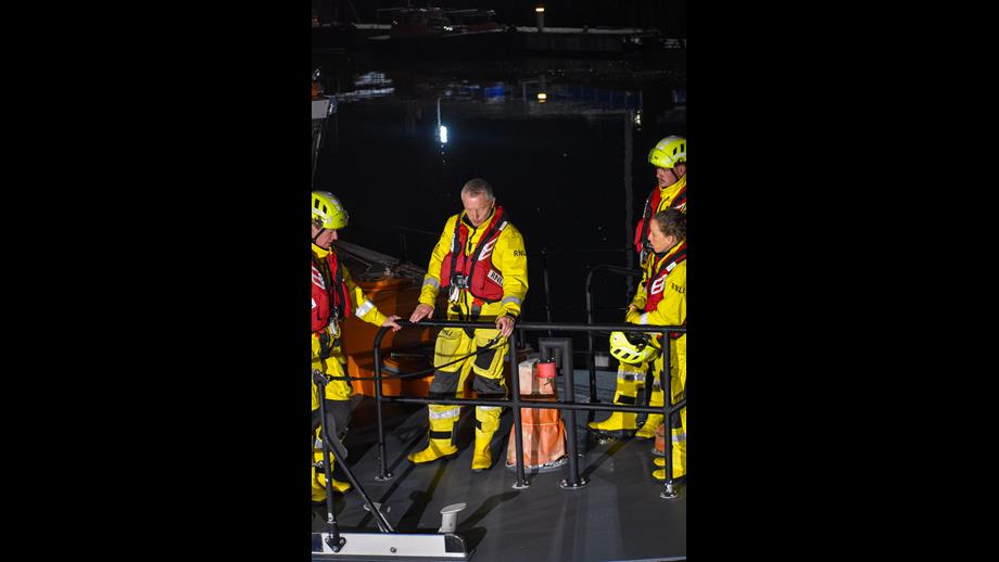 John with other crew members standing around during a training session
