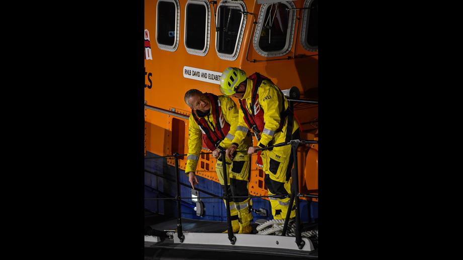 John standing next to another crew member during a training session.