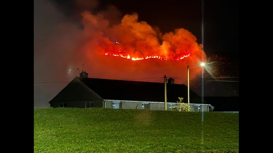 Port Talbot RNLI launch with the back drop mountain blaze to illuminate