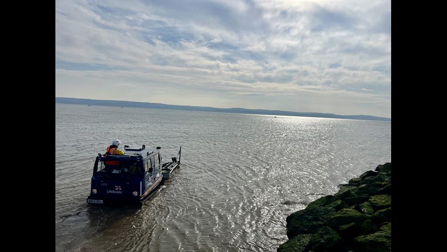 West Kirby BV launch vehicle manoeuvring into position to recover D class Lifeboat returning to shore