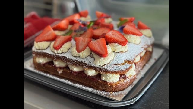 Jean Fowlers 75 years of volunteering celebration cake made by RNLI Blyth. Cream cake with strawberries on top
