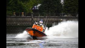 Chiswick’s RNLI E class lifeboat on the River Thames with wash spraying behind