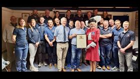 Mike being presented with a letter of thanks and long service award by Janey Howell and Philip Lay in front of the Penarth Crew