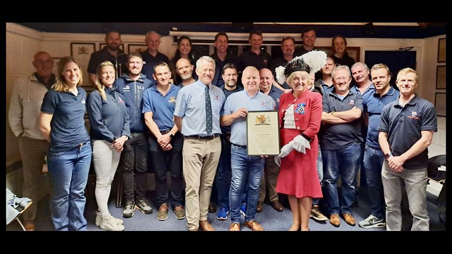Mike being presented with a letter of thanks and long service award by Janey Howell and Philip Lay in front of the Penarth Crew