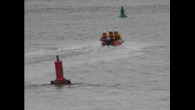 Wells RNLI inshore lifeboat Peter Wilcox launched to cut off by the tide three volunteers onboard in full RNLI inshore kit
