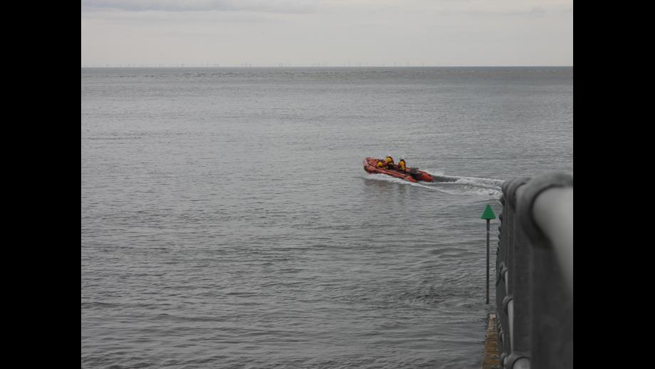 Wells RNLI inshore lifeboat Peter Wilcox launched to cut off by the tide three volunteers onboard in full RNLI inshore kit

