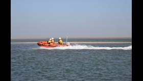 Wells D-class lifeboat 'Peter Wilcox' on cut off by tide launch on a sunny day with a volunteer crew of three in full inshore lifeboat kit