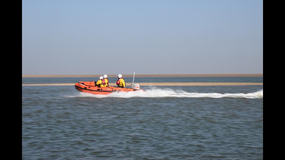 Wells D-class lifeboat 'Peter Wilcox' on cut off by tide launch on a sunny day with a volunteer crew of three in full inshore lifeboat kit