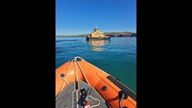 The view from the boarding boat as crew undergoing assessment prepare the tow line to pass to the casualty.