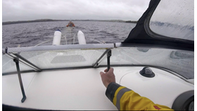View through open canopy of the casualty vessel, and ahead the tow line and Lough Derg RNLI Lifeboat Jean Spier