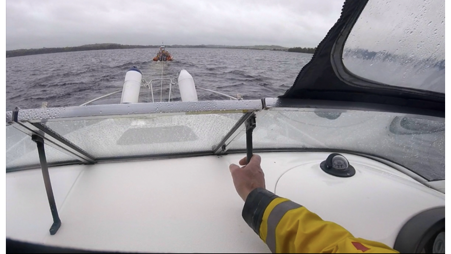 View through open canopy of the casualty vessel, and ahead the tow line and Lough Derg RNLI Lifeboat Jean Spier