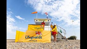 Lifeguards setting up a beach hut