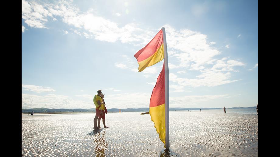 Two lifeguards keeping watch on a sandy beach