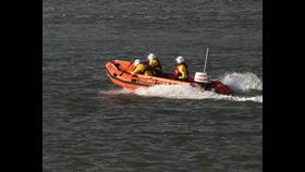 Wells RNLI Inshore Lifeboat Peter Wilcox assist four cut off by the tide. Lifeboat on open water with crew of 3