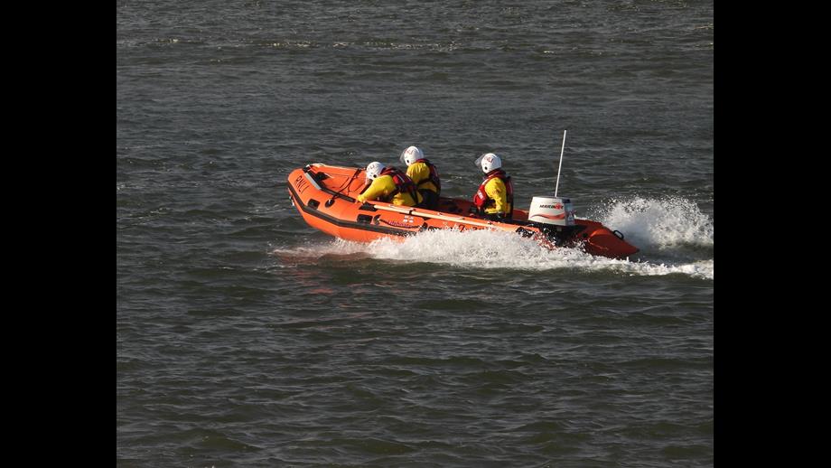 Wells RNLI Inshore Lifeboat Peter Wilcox assist four cut off by the tide. Lifeboat on open water with crew of 3
