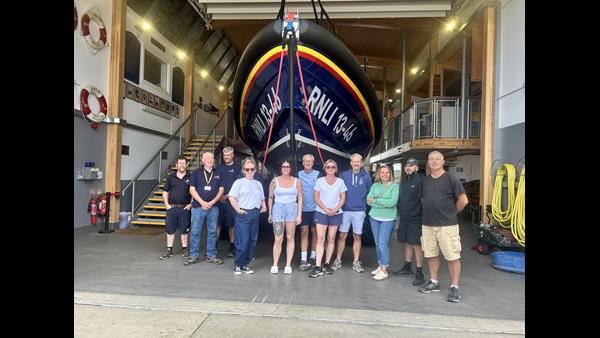 BM Solutions team roll up their sleeves to support Wells RNLI members of BM solutions and Wells RNLI in front of Shannon class lifeboat