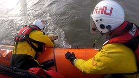 Dog alongside the lifeboat about to be recovered onboard
