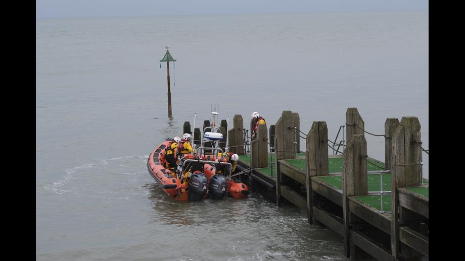Aberystwyth RNLI Lifeboat crew displaying capabilities of the Atlantic 85 at the official reopening of Aberystwyth's famous jetty.