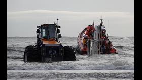 Tractor and lifeboat in swell close to shore